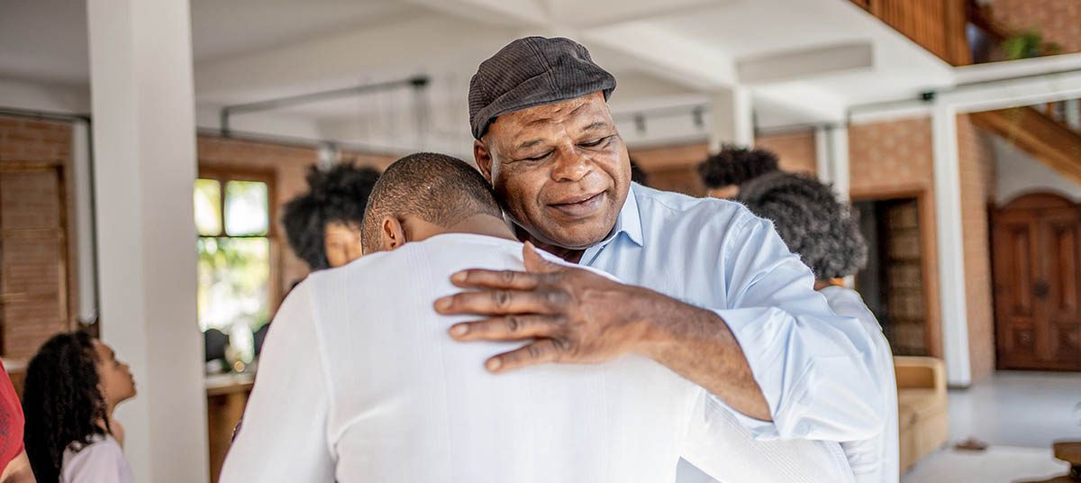 Two people hugging warmly indoors