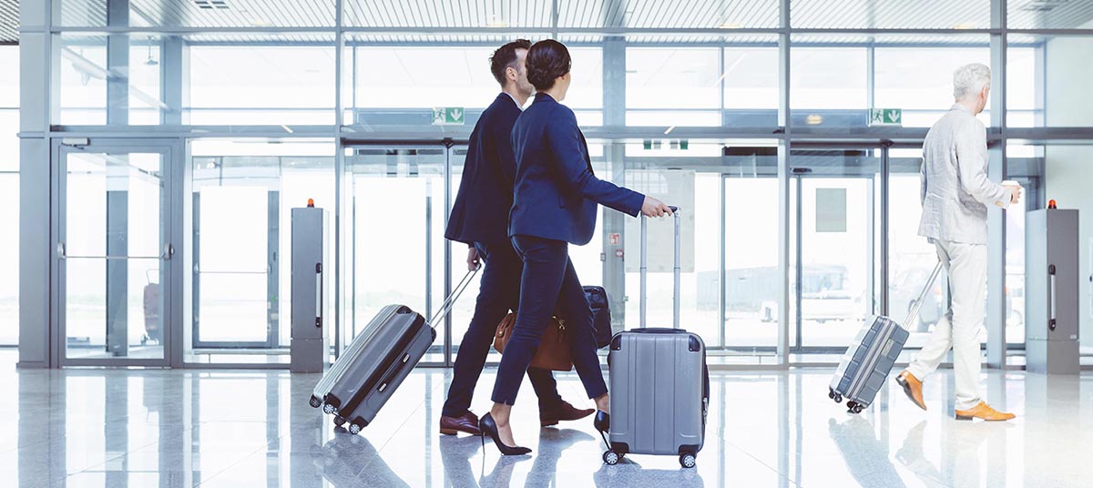 Business travelers with suitcases in terminal