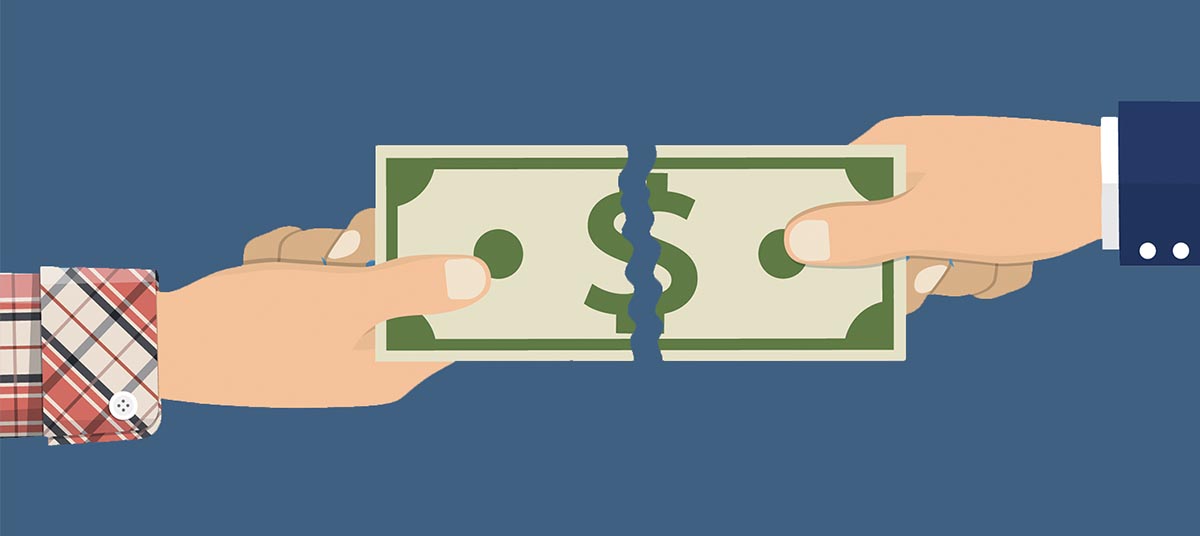 Two hands tearing a dollar bill