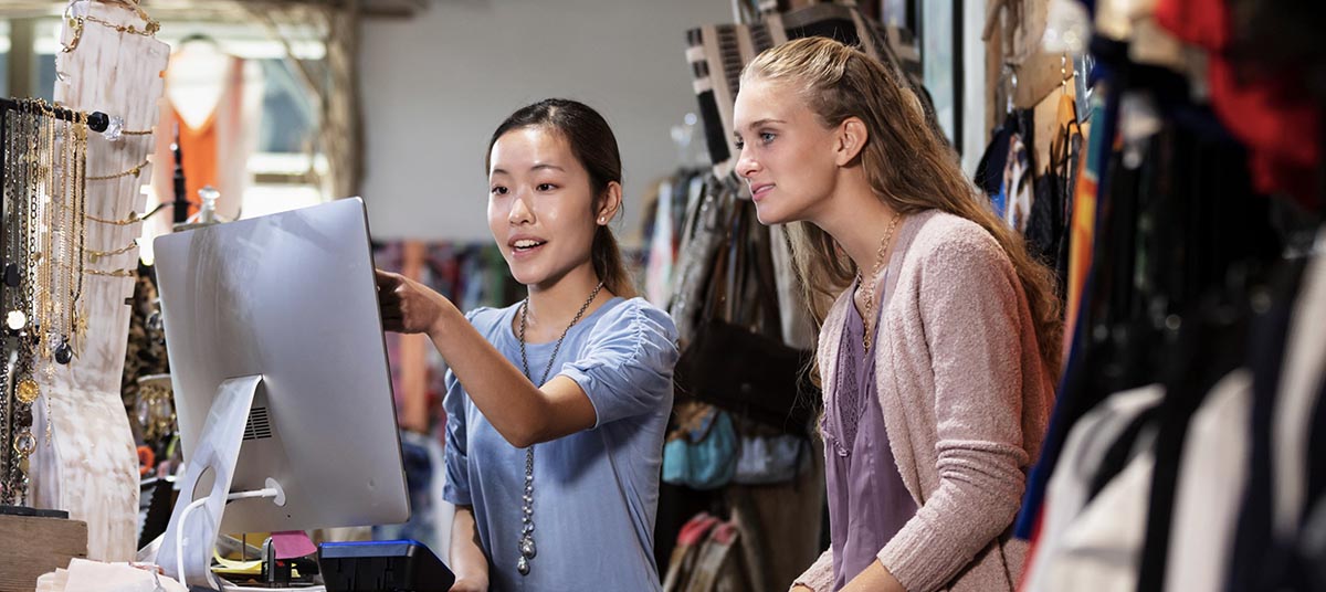 Two women browsing items in store