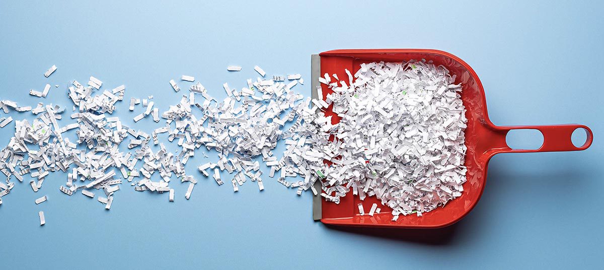 Shredded paper in a red dustpan