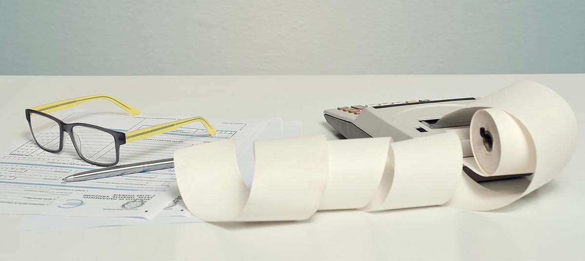 Glasses and calculator with paper roll