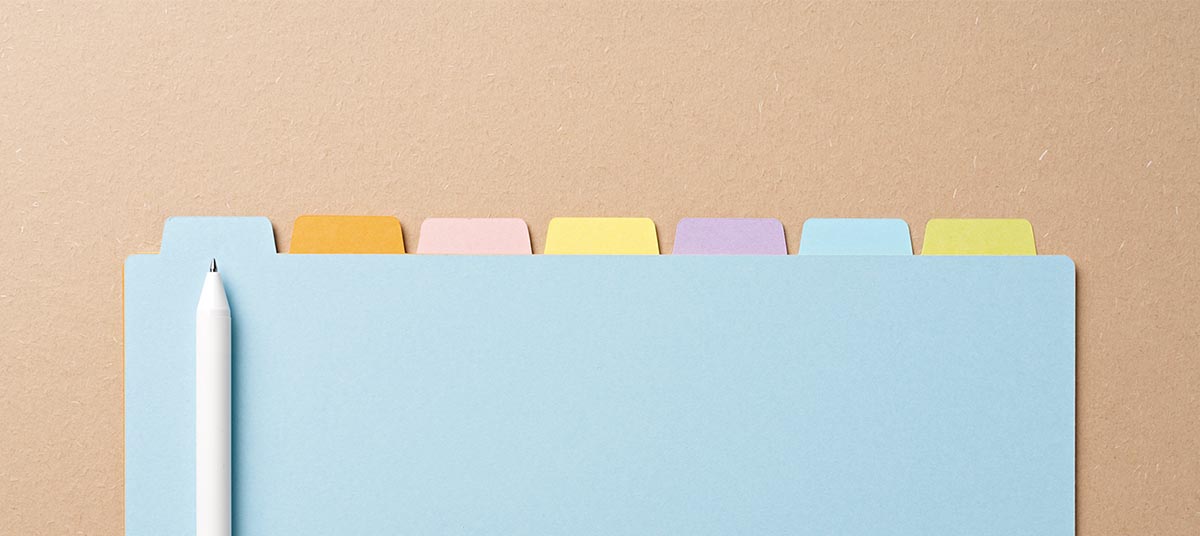 Colorful tabs on blue folder with pencil