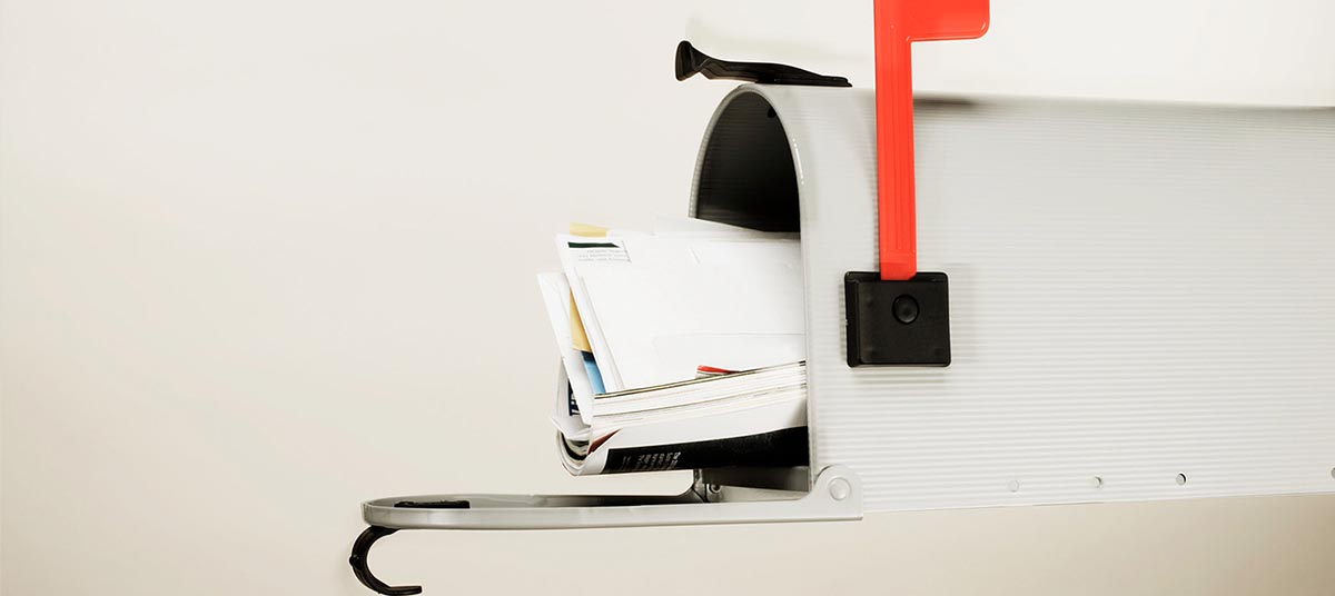 Open mailbox with overflowing letters