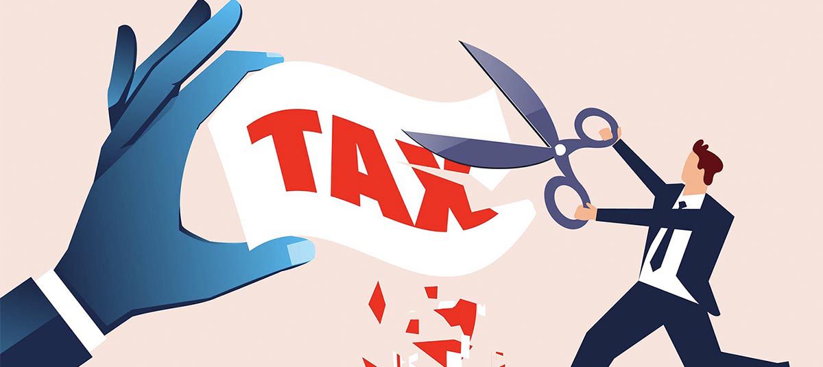 Person cutting tax paper with scissors