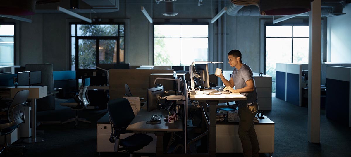 Person working late in dimly lit office.