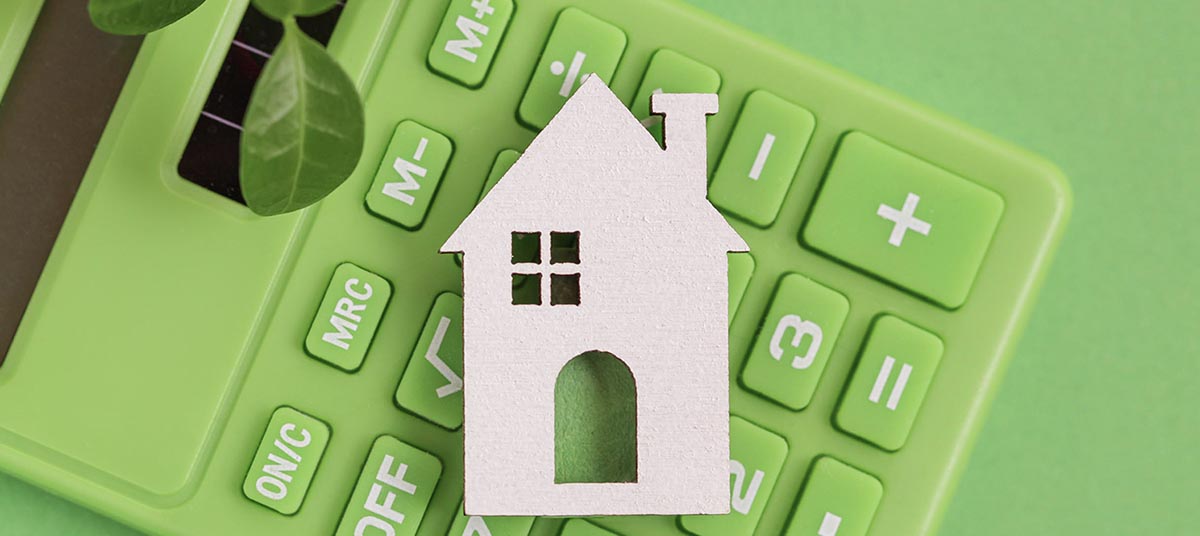 House cutout on green calculator