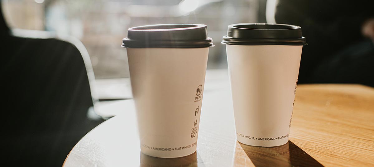 Sunlight shining on takeaway coffee cups.