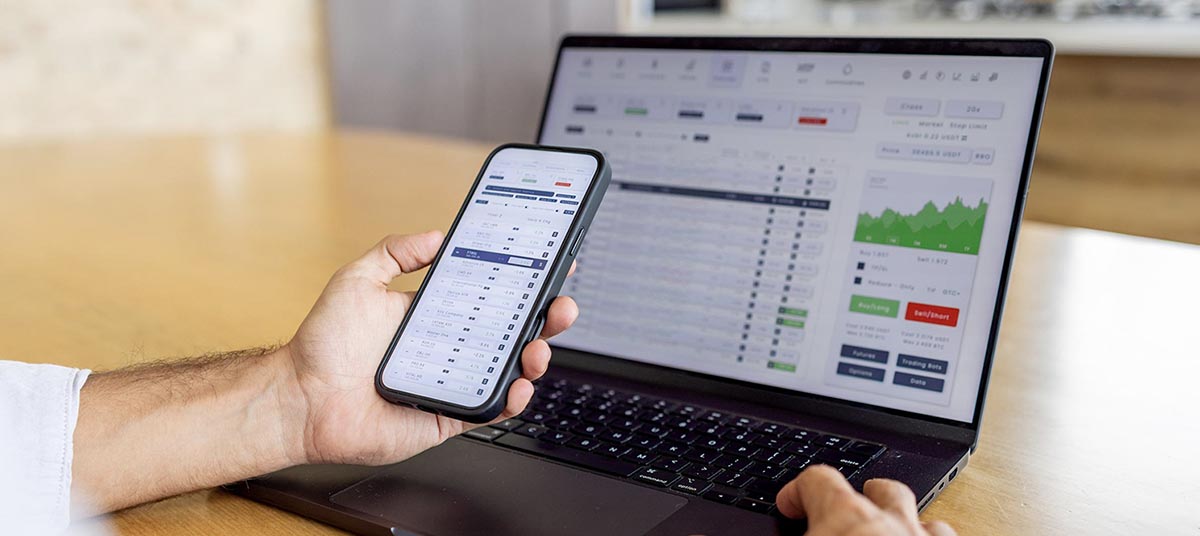 Analyzing data on phone and laptop screen
