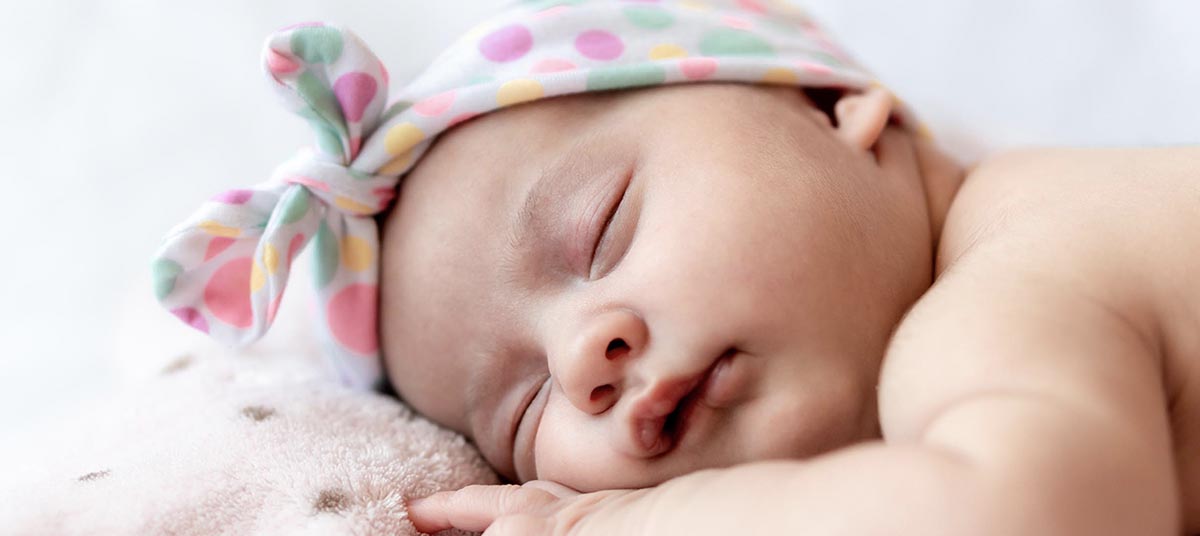 Sleeping baby with polka dot headband
