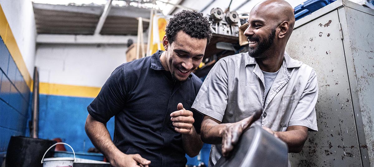 Two men smiling in garage