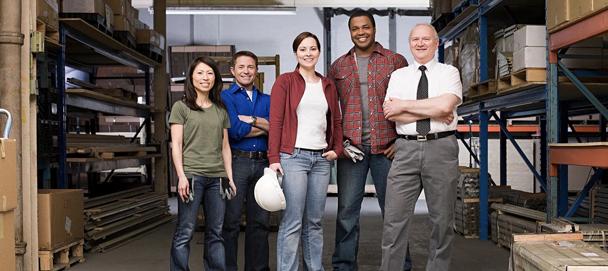 Warehouse team standing together in aisle