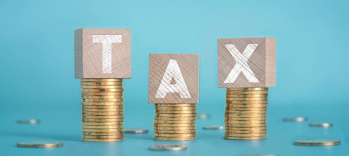 Coins stacked with tax blocks on top