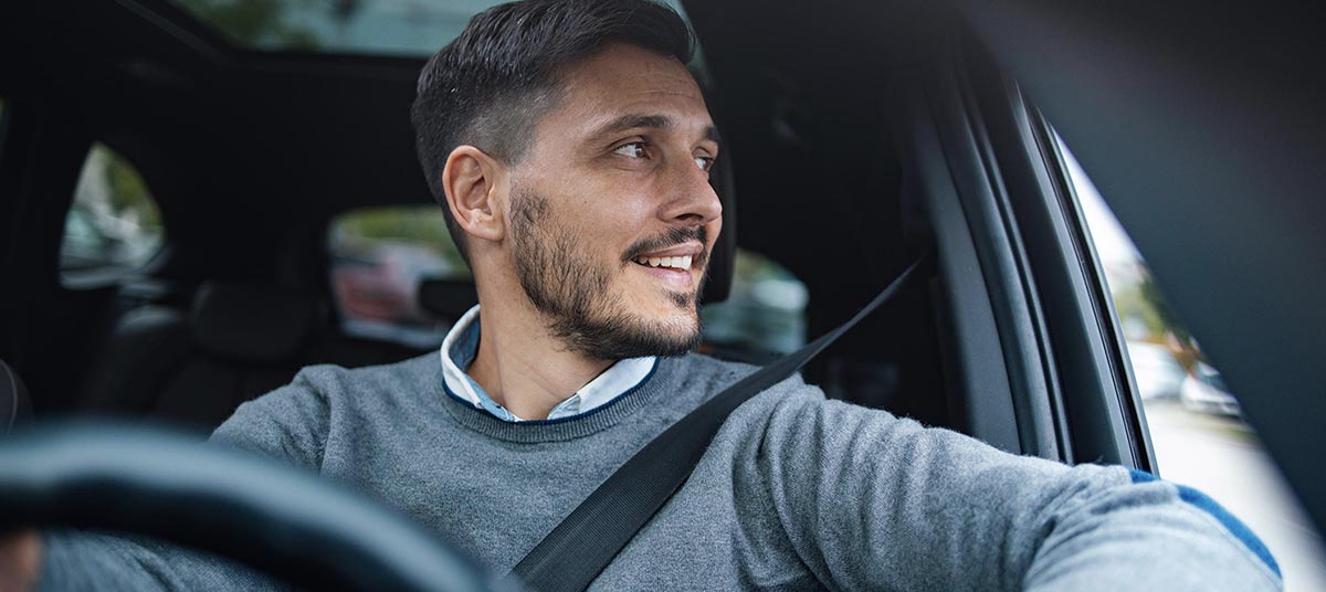 Man in car wearing seatbelt