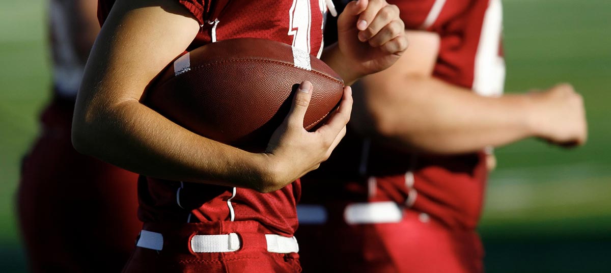 Close-up of football in player's hands