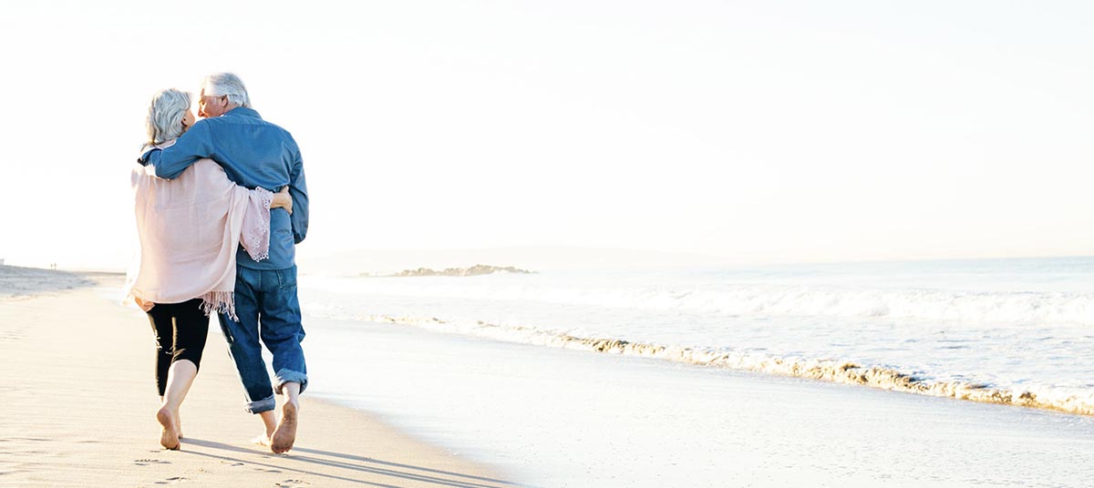 Seniors strolling by the ocean