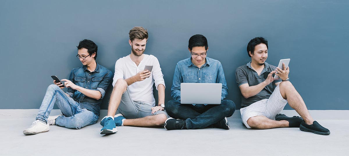 Group of men using electronic devices