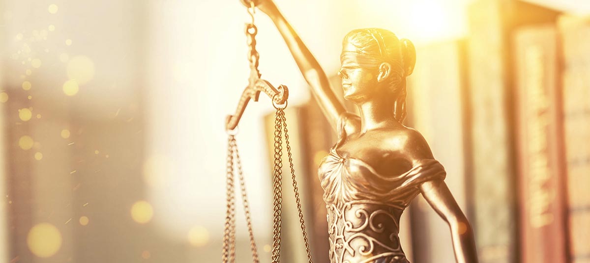 Blindfolded Lady Justice statue with scales
