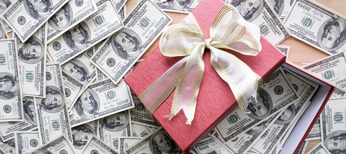 Gift box surrounded by dollar bills