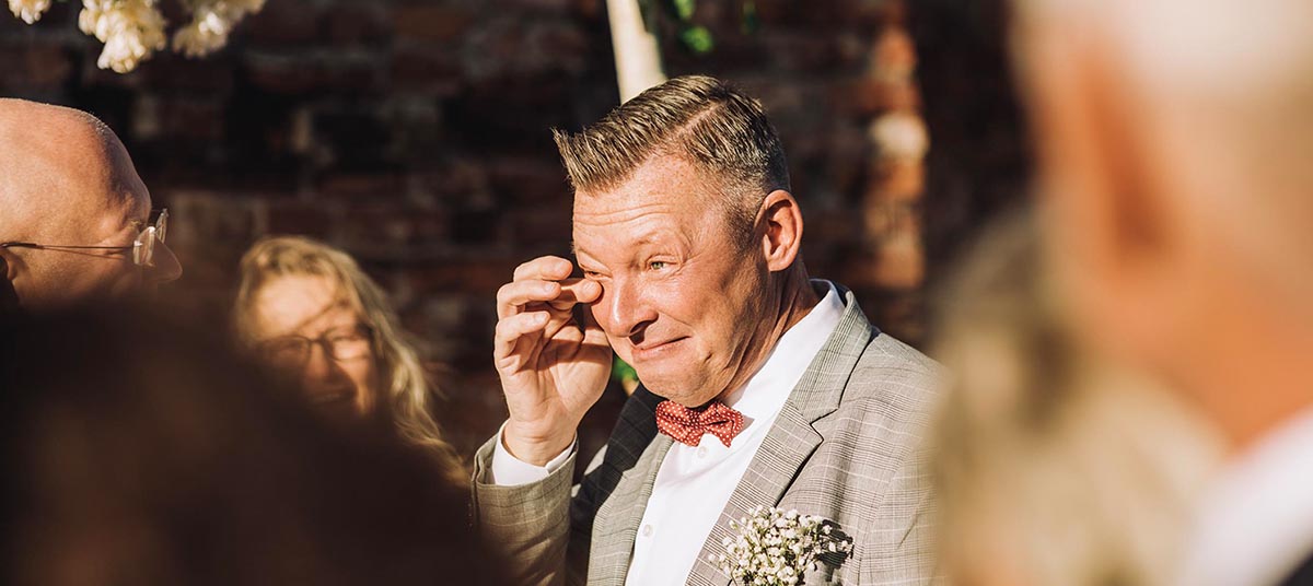 Man tearing up during wedding ceremony