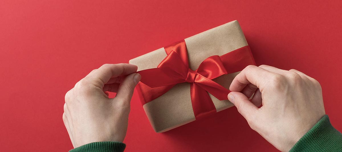 Present with red bow on red background