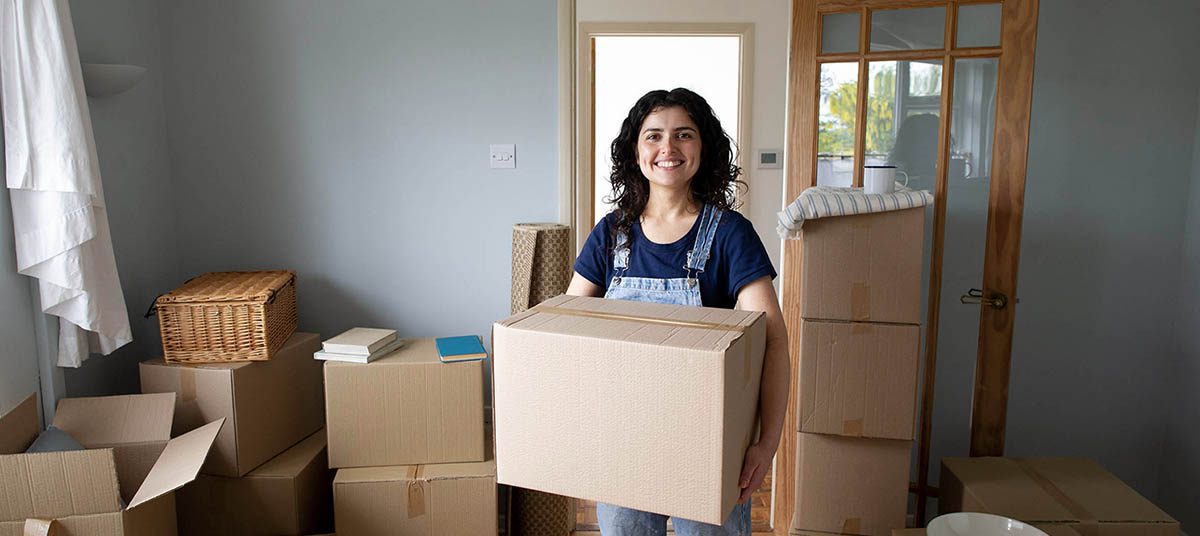 Happy woman moving into new home