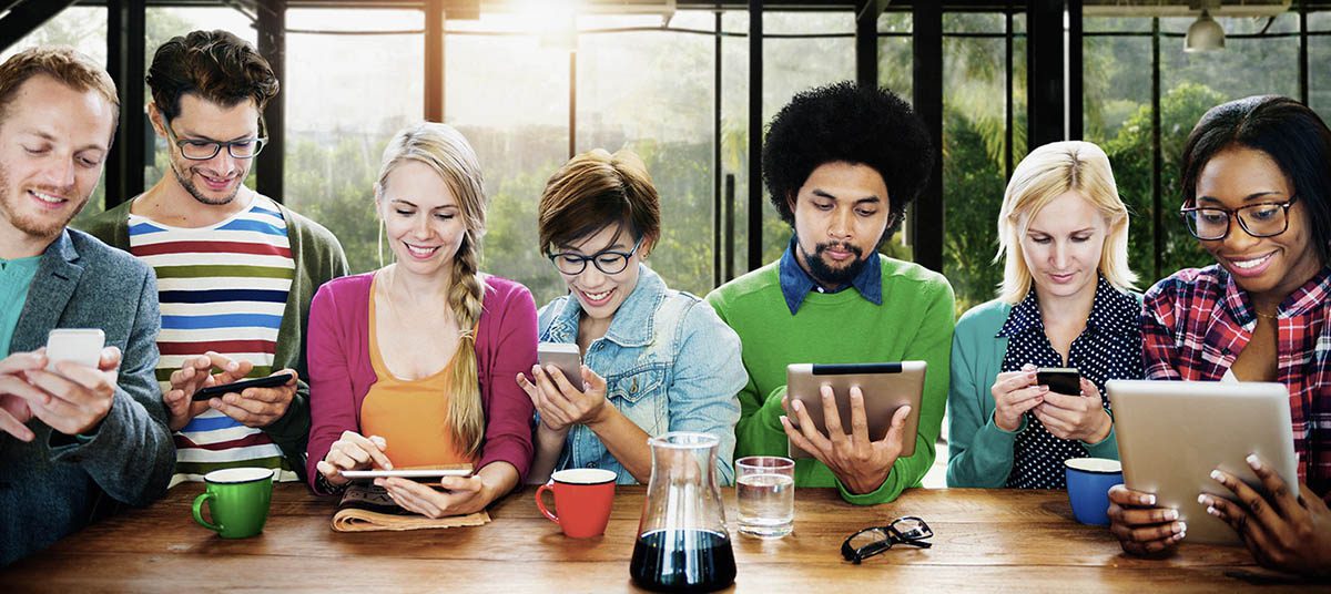 Diverse friends interacting with gadgets