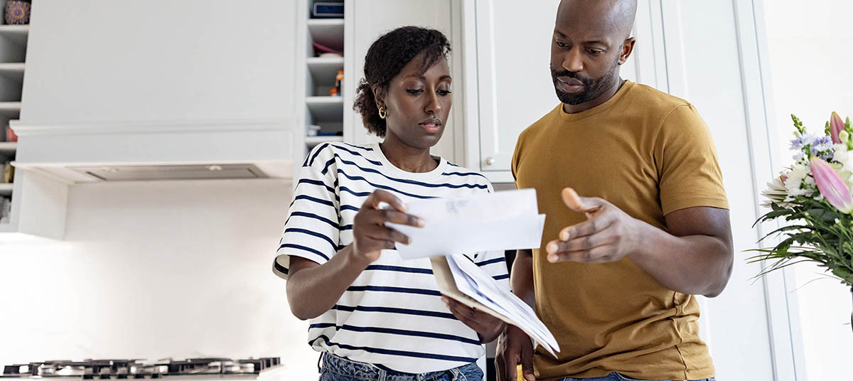 Couple reviewing documents in kitchen