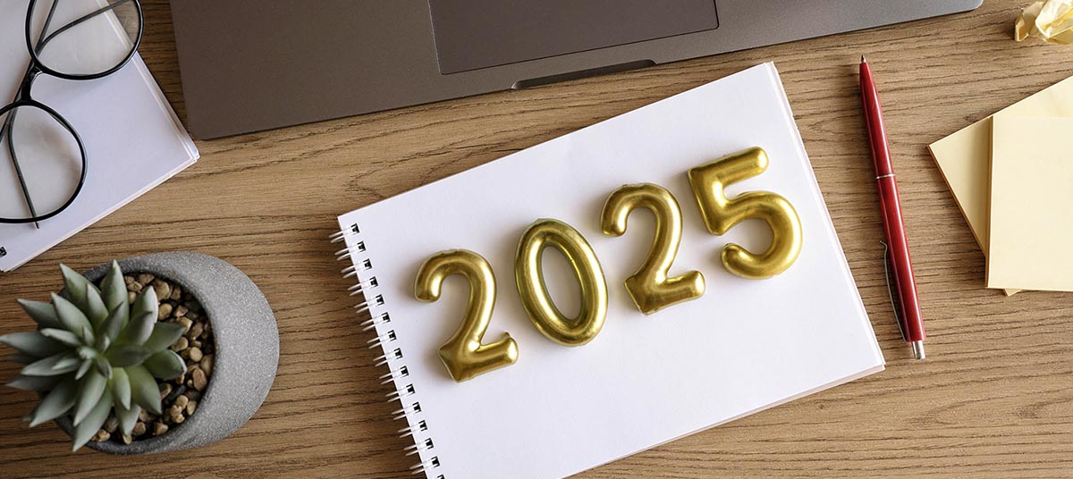 Gold numbers 2025 on wooden desk