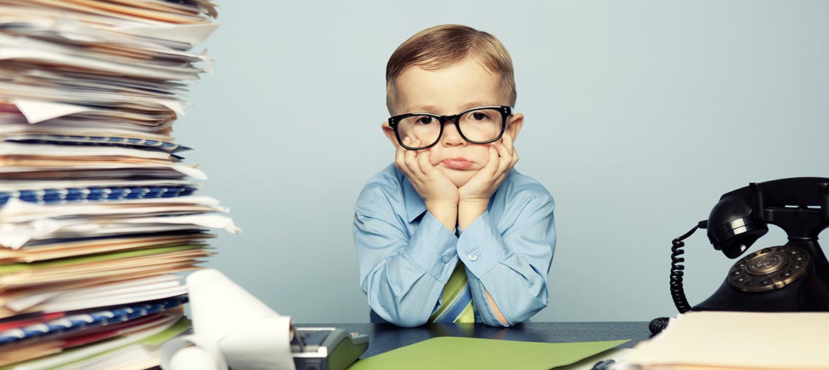 Kid in office attire with documents
