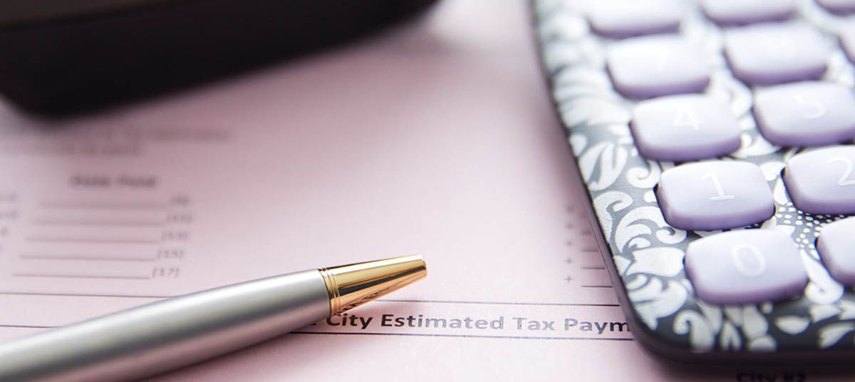 Pen and calculator on tax document
