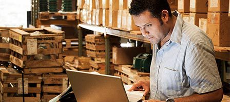 Warehouse worker using computer