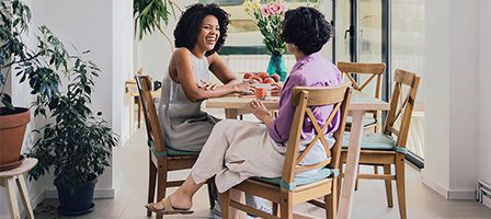Women chatting at a cozy dining table.