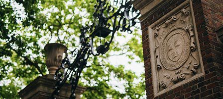 Intricate stone plaque on brick pillar