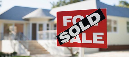 Sold house with sign in front