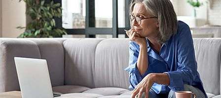 Woman using laptop on sofa