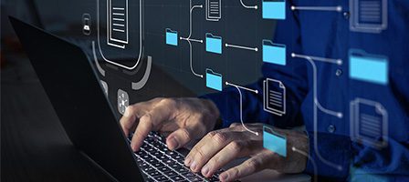 Person working on laptop with technology graphics