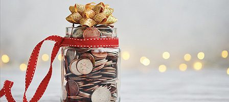 Savings jar wrapped in holiday ribbon
