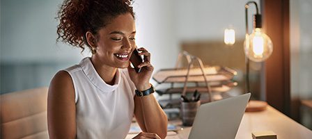 Woman working on a laptop and phone