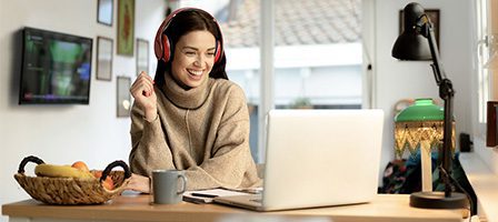 Smiling woman working remotely at home