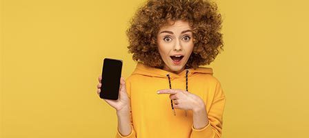Curly-haired woman with phone