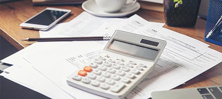 Office desk with calculator and documents
