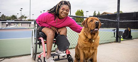 Smiling woman and large brown dog