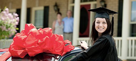 Graduate smiling with new car gift