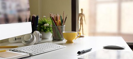 Modern workspace with computer and stationery