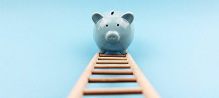 Blue piggy bank on a ladder
