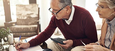 Elderly couple managing finances together