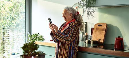 Woman in colorful robe near kitchen counter