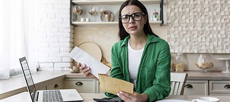 Concerned woman reviewing paperwork at home