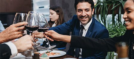 Group celebrating with wine glasses